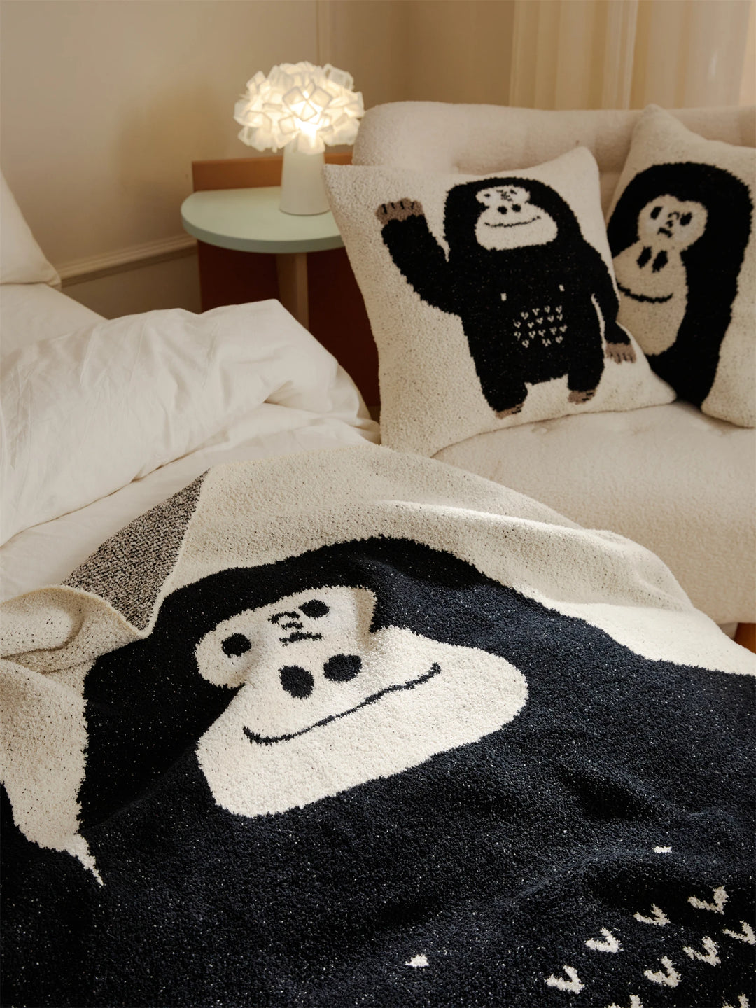 Close-up of the black and ivory gorilla design on a plush throw blanket