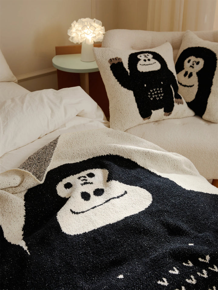 Close-up of the black and ivory gorilla design on a plush throw blanket
