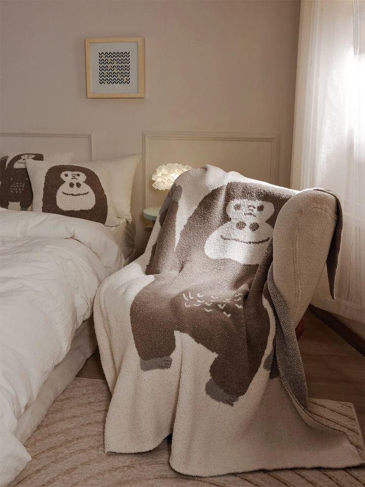 Brown and ivory throw blanket with a cartoon gorilla design