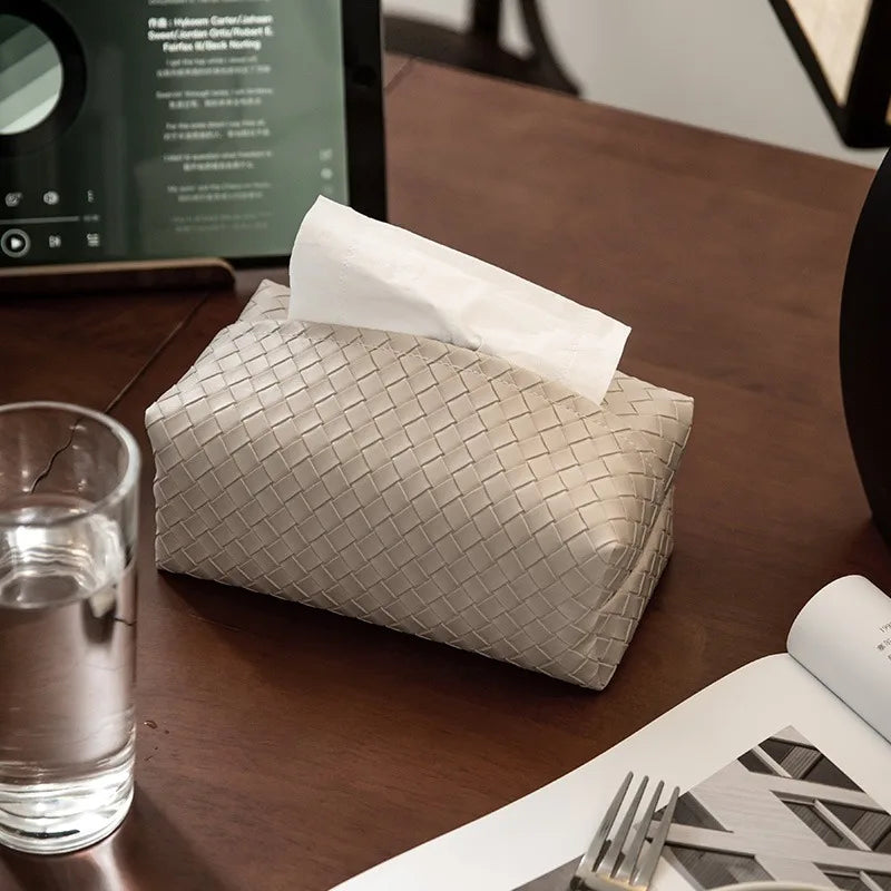 Beige woven leather rectangle tissue holder with a tissue protruding from the top