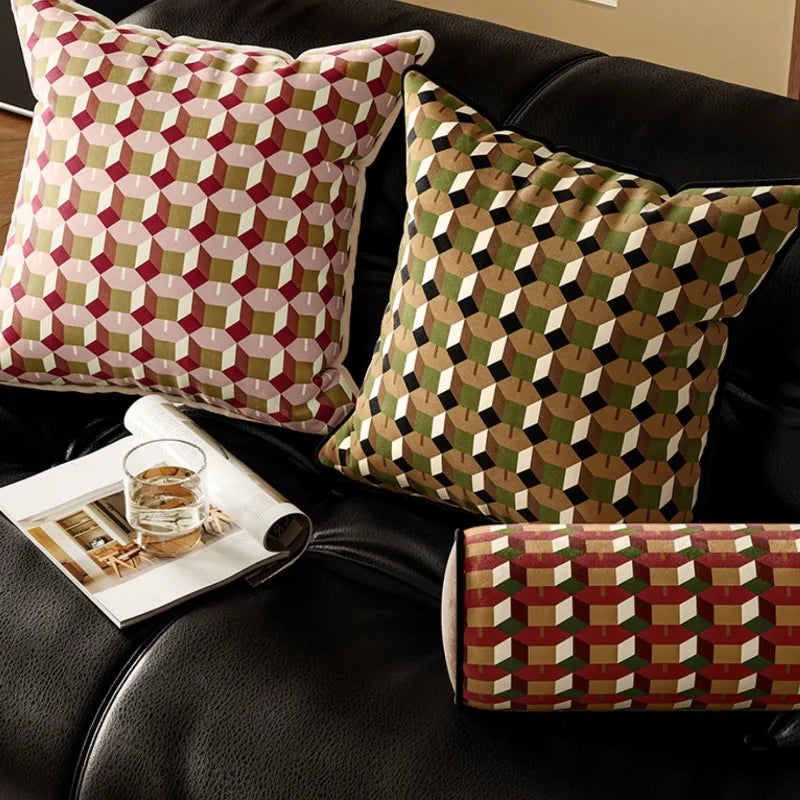 Geometric pillows in pink, brown, and green patterns, including square and lumbar styles