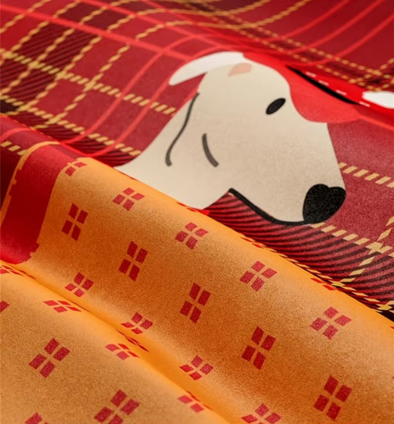 Close-up of red plaid greyhound pillow fabric and its orange patterned reverse