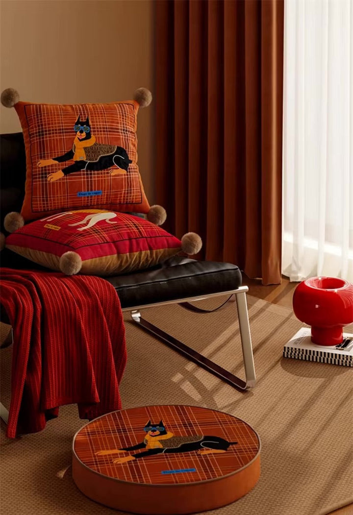 Scottish dog pillows with plaid covers, pom-pom corners and illustrated dog designs