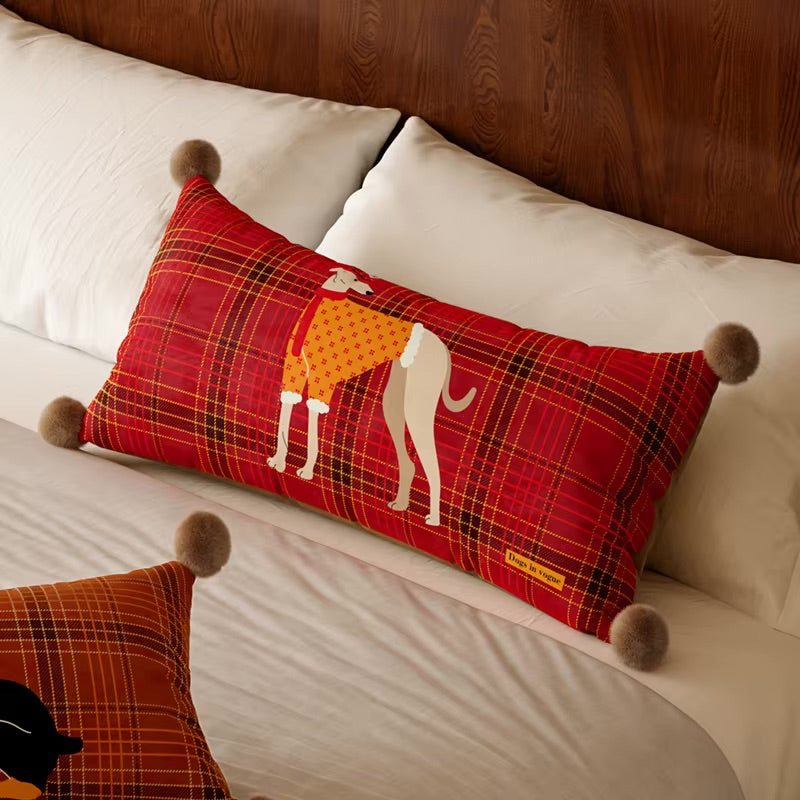 Red plaid lumbar dog pillow with a greyhound illustration and pom-pom corners
