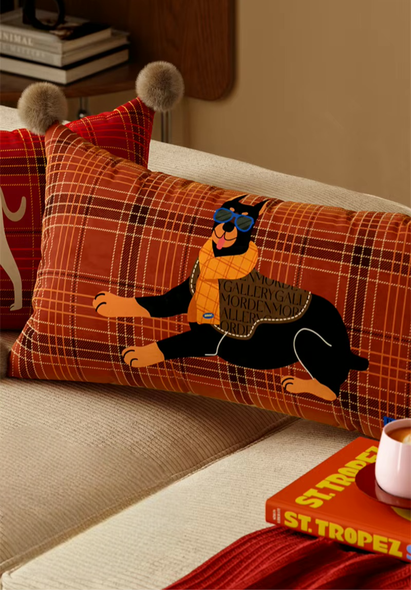 Rust plaid rectangular pillow with a black Doberman print and pom-pom corners