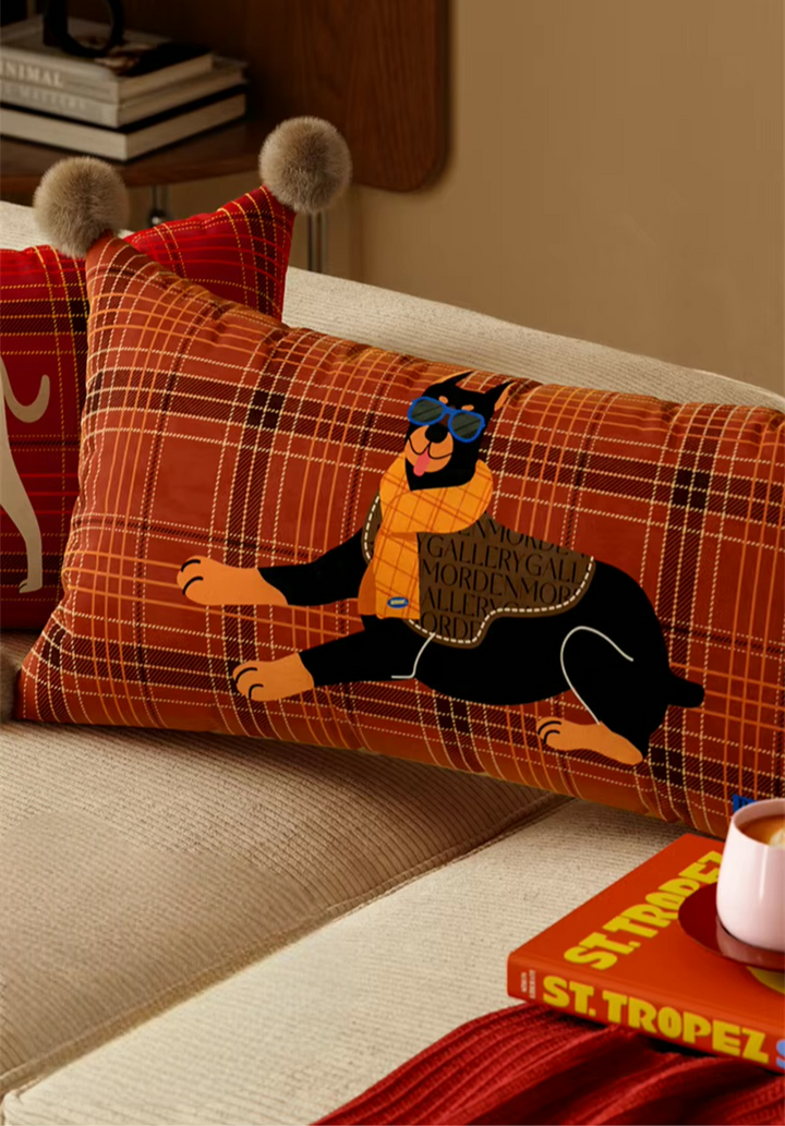 Rust plaid rectangular pillow with a black Doberman print and pom-pom corners