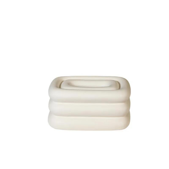 White square tissue holder with rounded stacked ridges and a recessed top opening