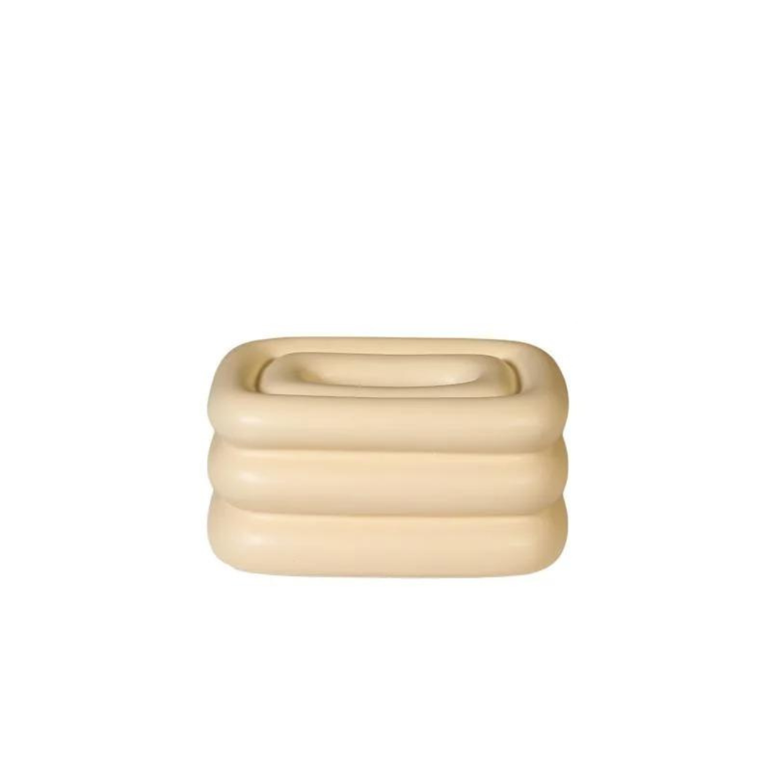 Creamy yellow square tissue holder with rounded stacked ridges and a recessed top opening