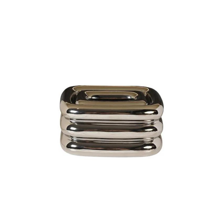 Silver square tissue holder with rounded stacked ridges and a recessed top opening