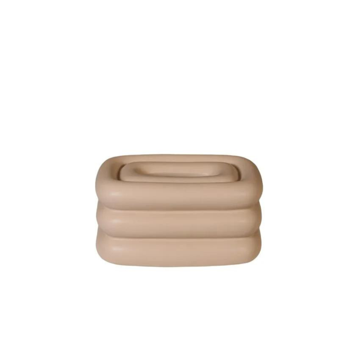 Light brown square tissue holder with rounded stacked ridges and a recessed top opening