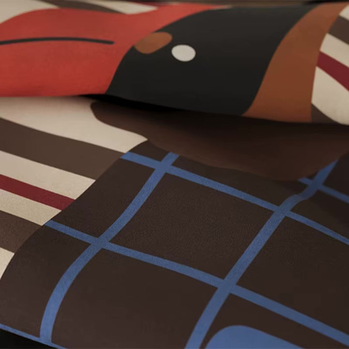 Close-up of a dog-print pillow fabric with blue grid and stripe details