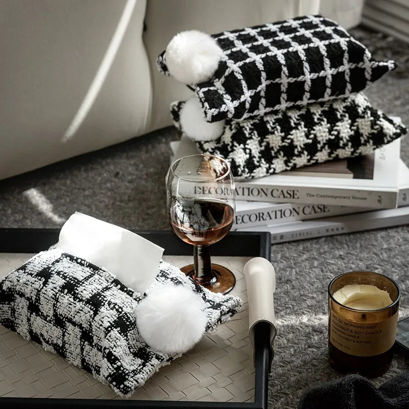 Woven tissue holders with white pom-poms in black and white geometric patterns