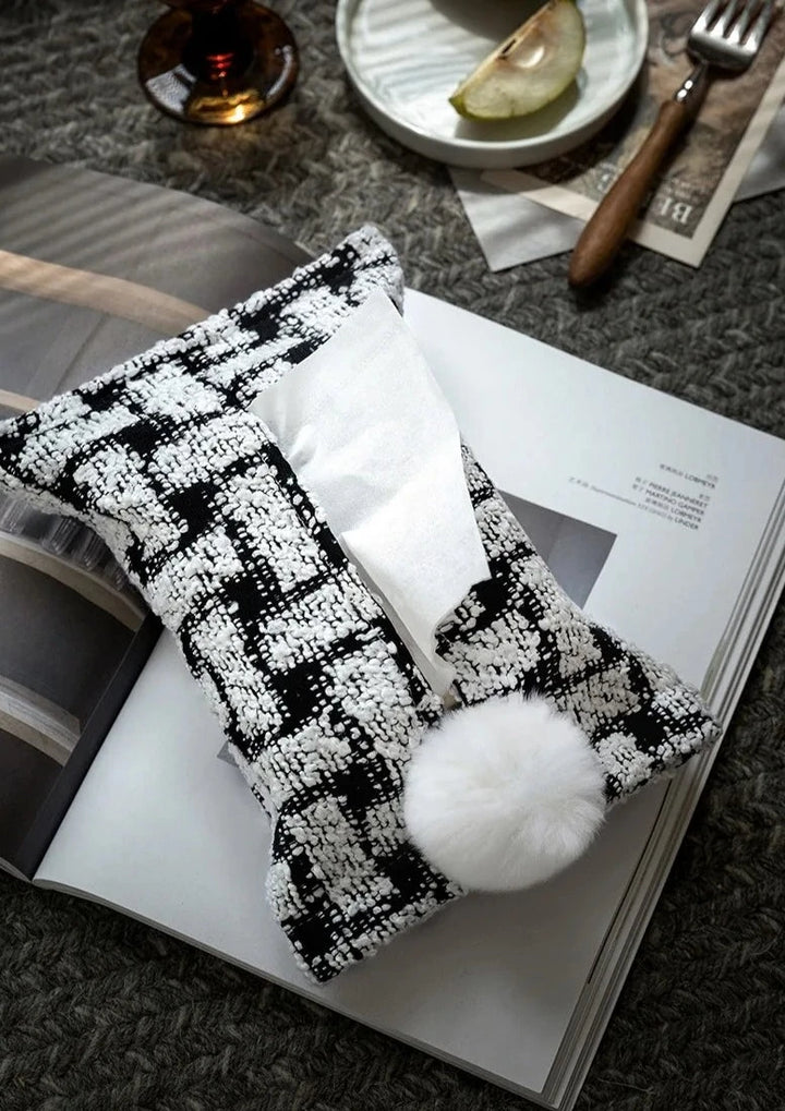 Black and white patterned woven tissue holder with tissue opening and white pom-pom