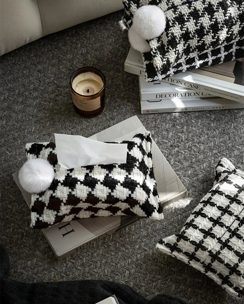 Black and white checker woven tissue holder with white pom-pom and visible tissue