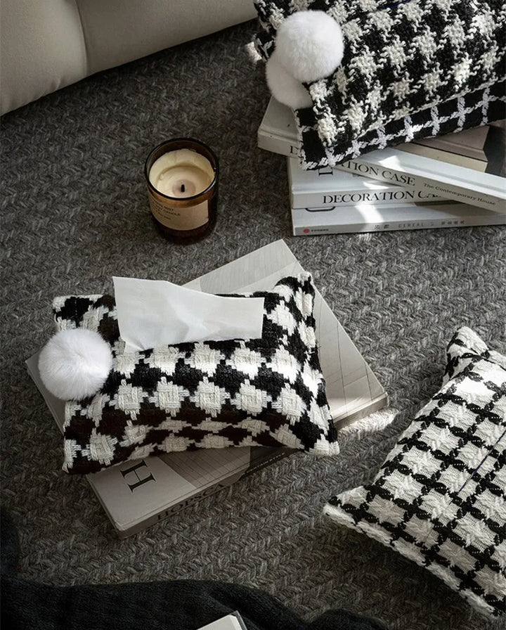 Black and white checker woven tissue holder with white pom-pom and visible tissue