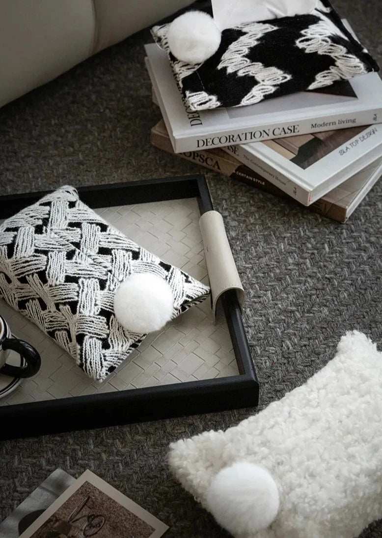 Woven tissue holders with white pom-poms in black and white patterns
