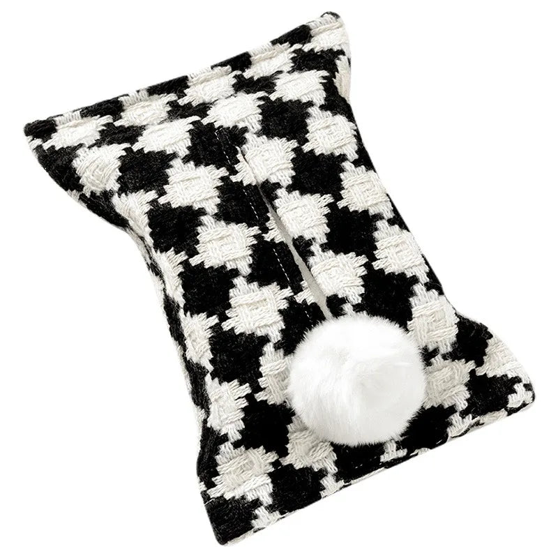 Black and white houndstooth tissue pouch with a white bunny-tail pom-pom.
