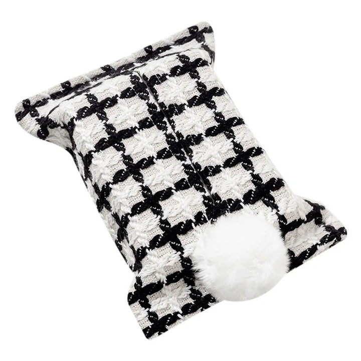 White tissue pouch with a black grid and white bunny-tail pom-pom.