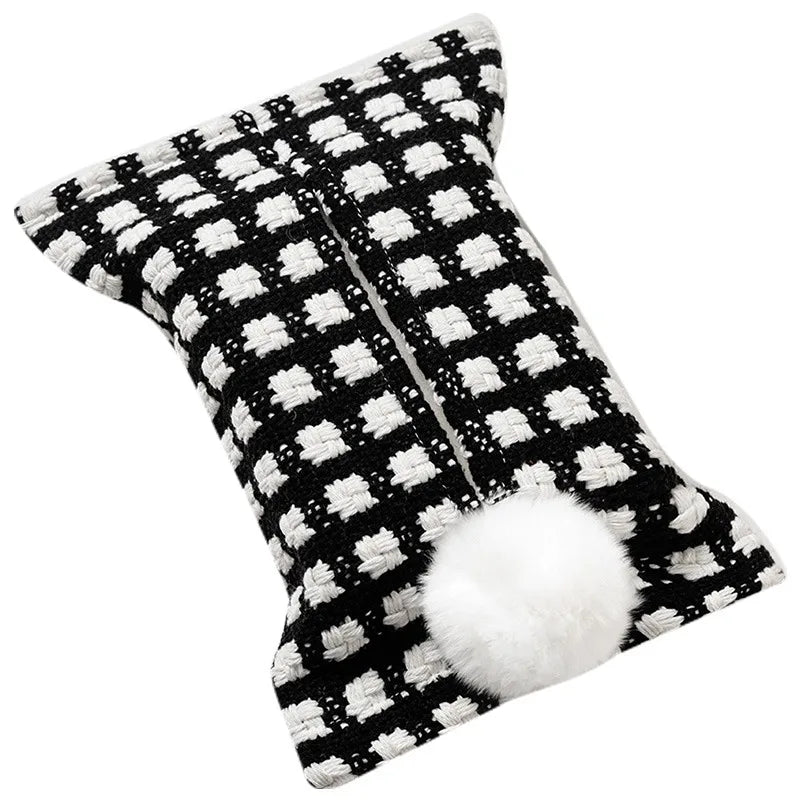 Black tissue pouch with small white checks and a white bunny-tail pom-pom.