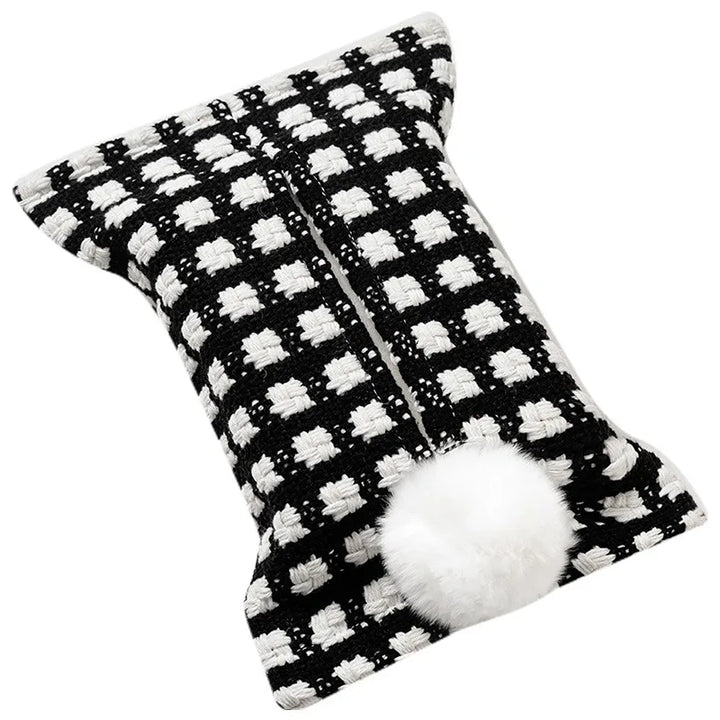 Black tissue pouch with small white checks and a white bunny-tail pom-pom.