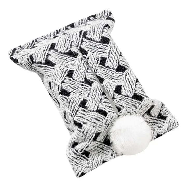 Black and white basketweave-pattern tissue pouch with a white bunny-tail pom-pom.