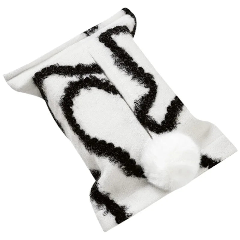 White tissue pouch with black wavy lines and a white bunny-tail pom-pom.