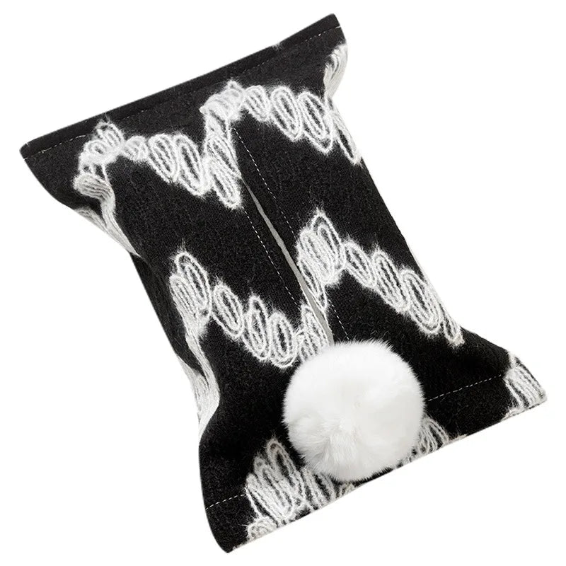 Black tissue pouch with large white zigzags and a white bunny-tail pom-pom.