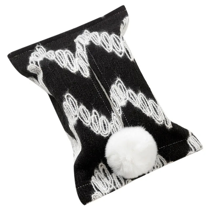 Black tissue pouch with large white zigzags and a white bunny-tail pom-pom.